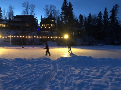 Two people skating on ice-covered Crimson Lake